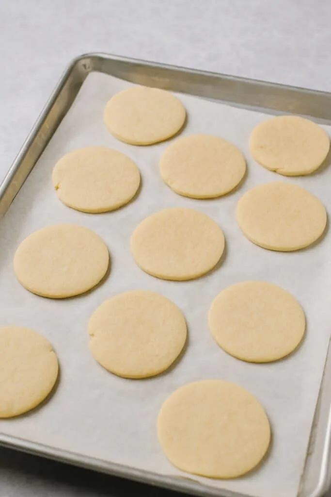 Sugar Cookies on a parchment-lined baking sheet