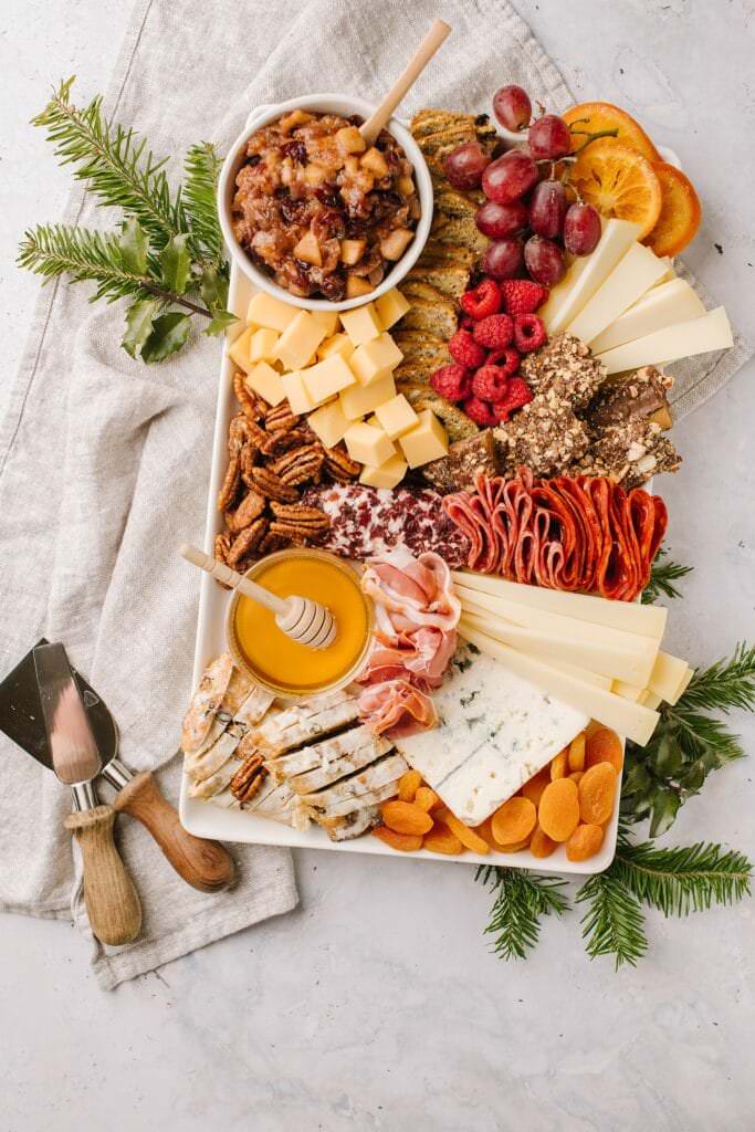 overhead shot of cheese board with cheese tools on the left side
