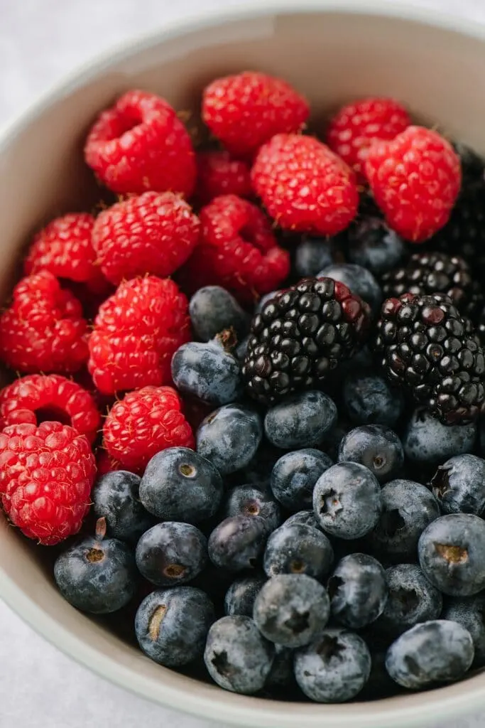 close up of bowl of raspberries, blueberries, and blackberries