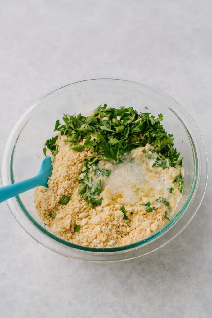 cracker crumbs, parsley, and melted butter in a bowl