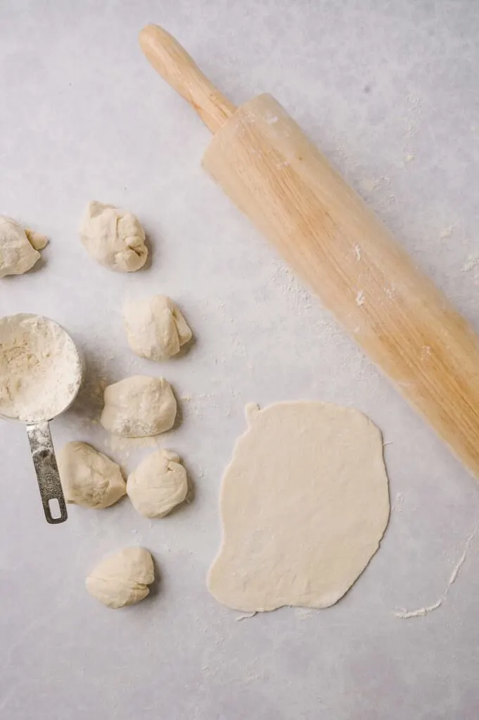 rolling out matzo dough with a rolling pin
