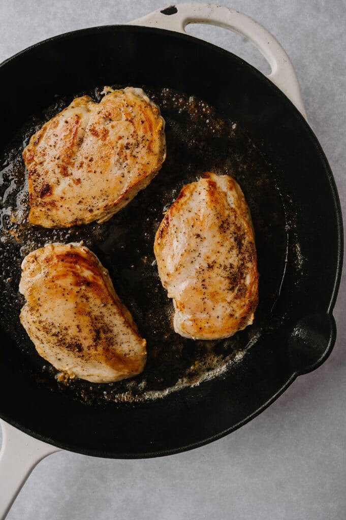 cooking chicken in a cast iron skillet