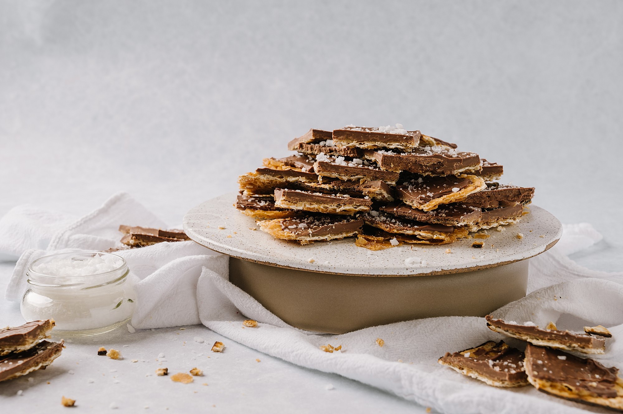 salted toffee matzah on a cake stand