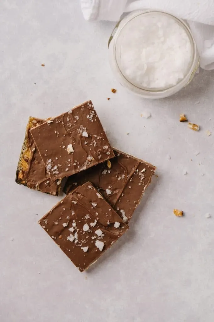 Salted Toffee Matzah pieces with a bowl of sea salt next to them