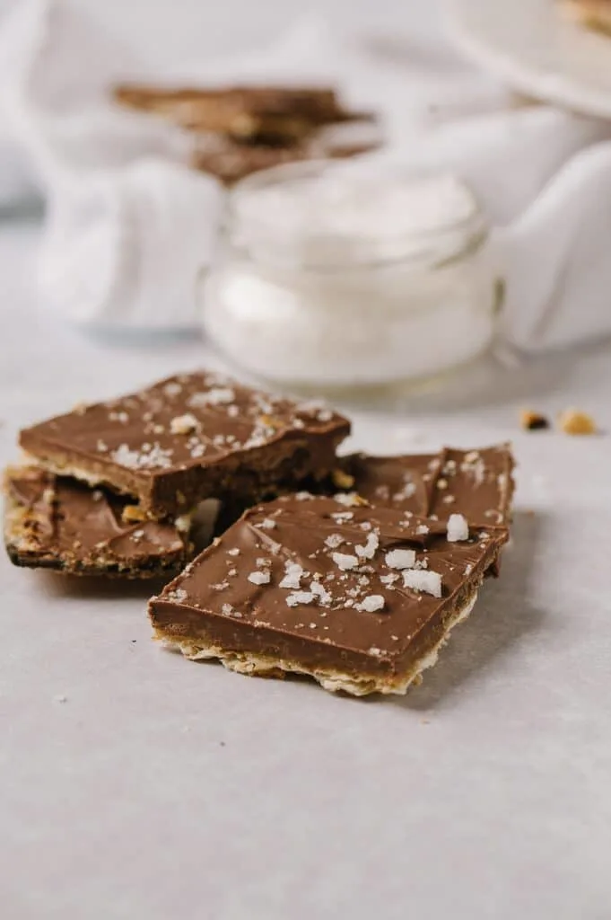 pieces of salted matzah toffee with sea salt in the background