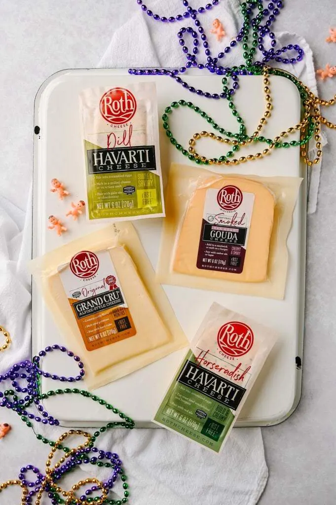 roth cheeses on a platter surrounded by mardi gras beads
