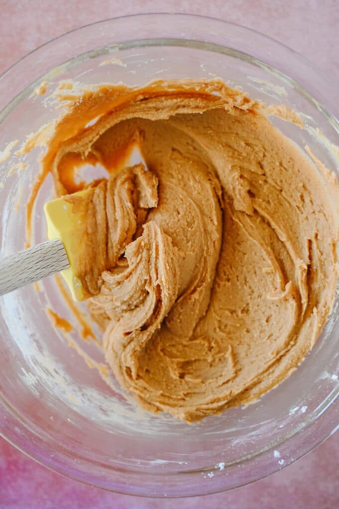 peanut butter ball mixture after being well mixed in a clear bowl