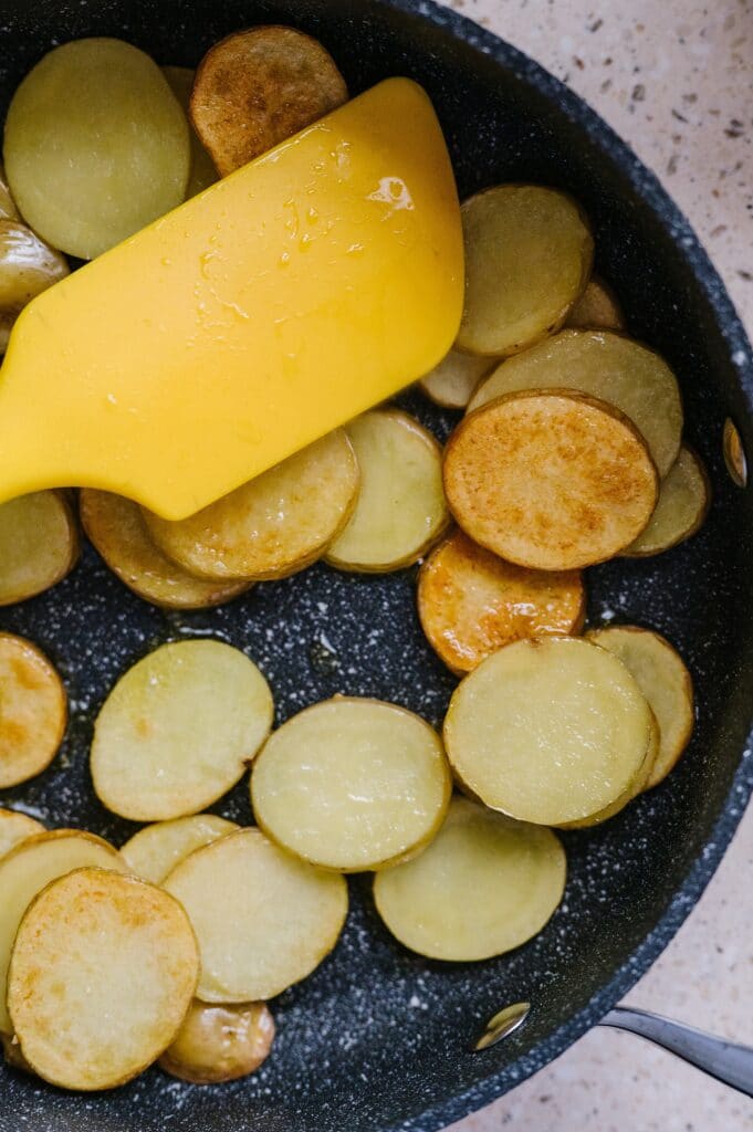 Yukon Gold potatoes in a pan being cooked