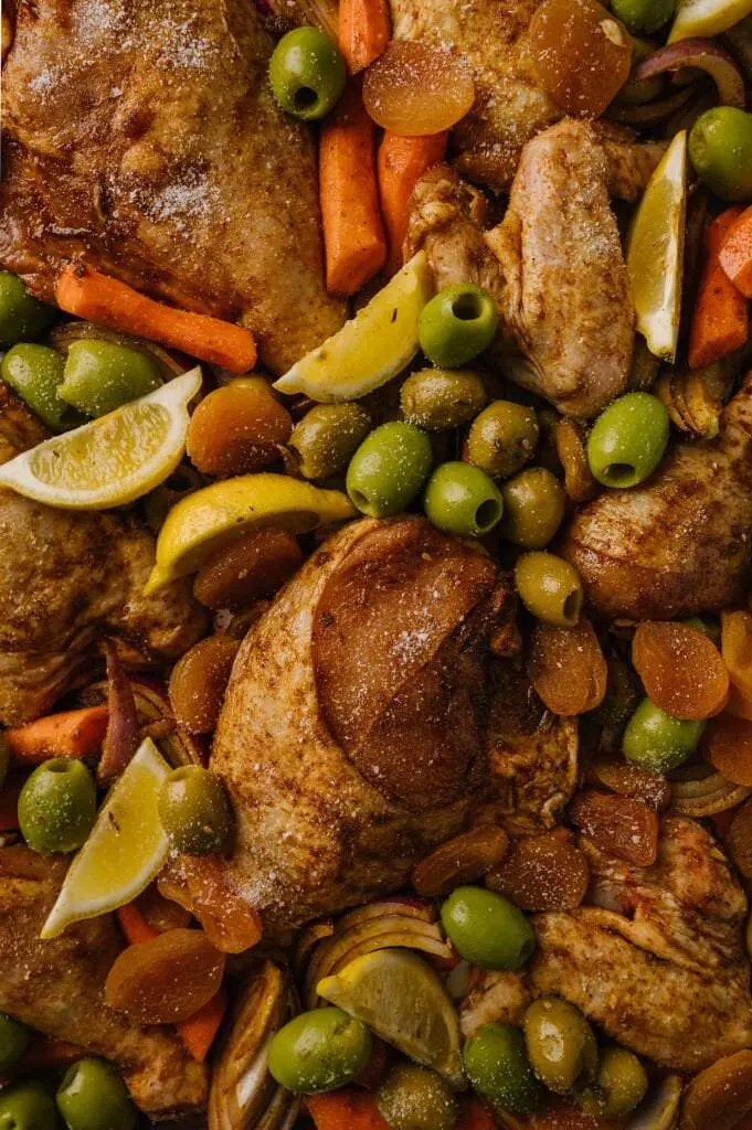 close up of morrocan sheet pan chicken and vegetables on a sheet pan