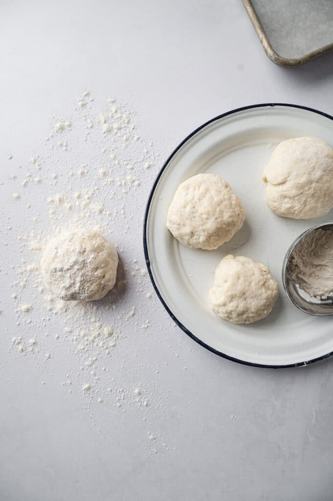 flatbread dough in four balls resting