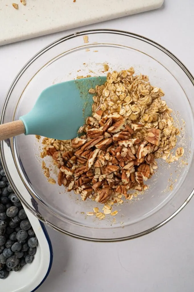 mixing ingredients for gluten free blueberry crisp