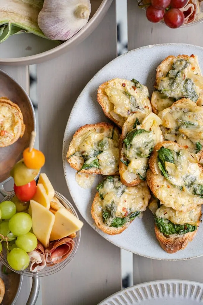 spinach and artichoke crostini on a plate
