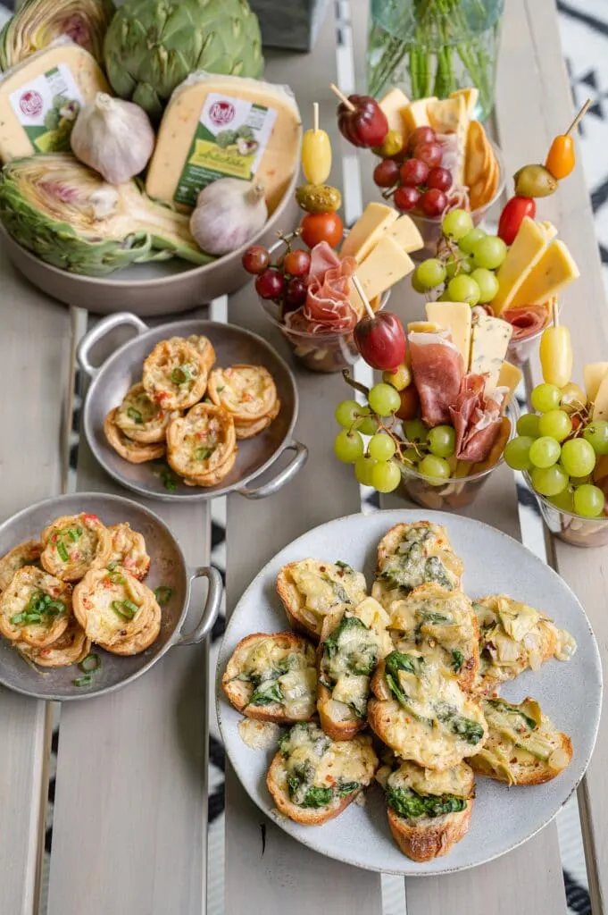 three spinach and artichoke appetizers on a table