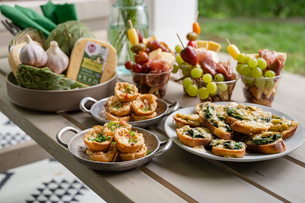three spinach and artichoke appetizers on a table