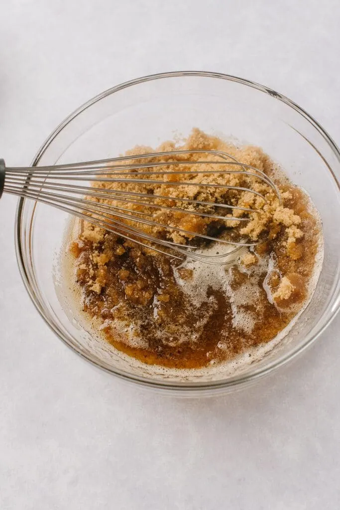 mixing brown sugar and butter in a bowl