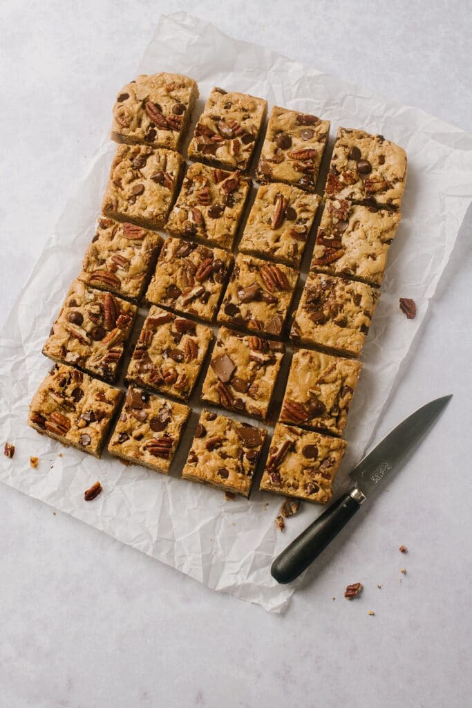 overhead shot of brown butter blondies cut into squares with a knife