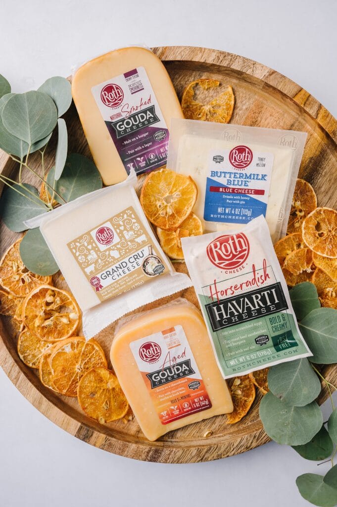 Roth cheeses on a platter with dried orange and eucalyptus
