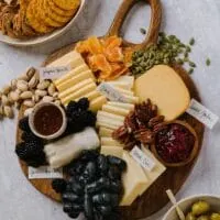 cheese board with roth cheese grapes, honey, and cracker